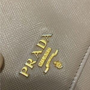 Preowned Beige Prada wallet w/ gold on inside
